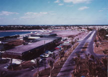 Area behind tennis courts being cleared for construction of marina inn.  Building in foreground housed a grocery store, member's lounge and cart rental.  Now the Everglades Complex